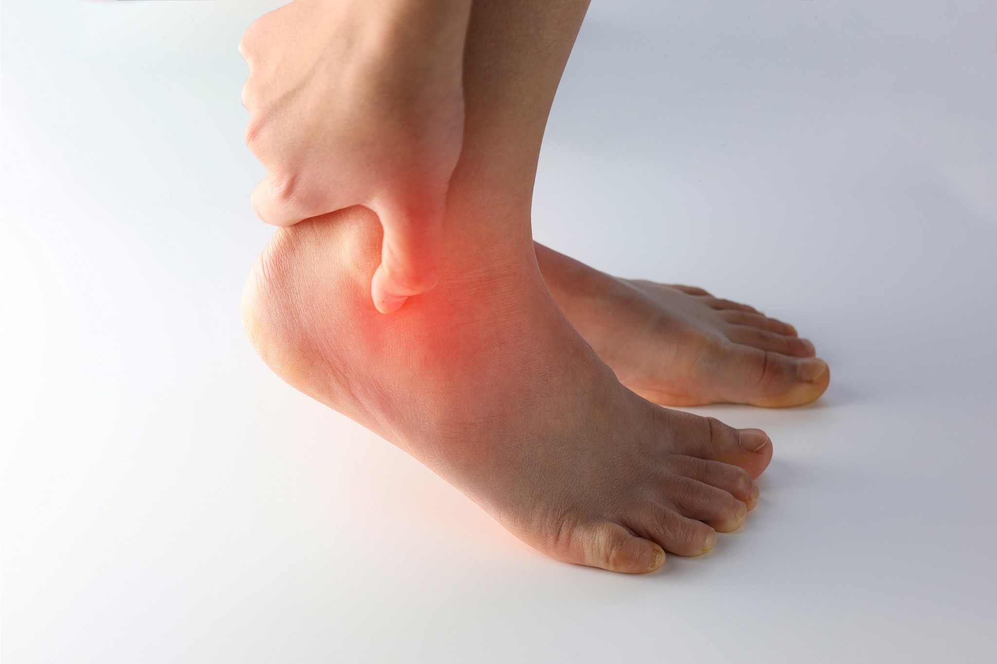 Untitled design (88) red circle on person's ankle, showing pain
