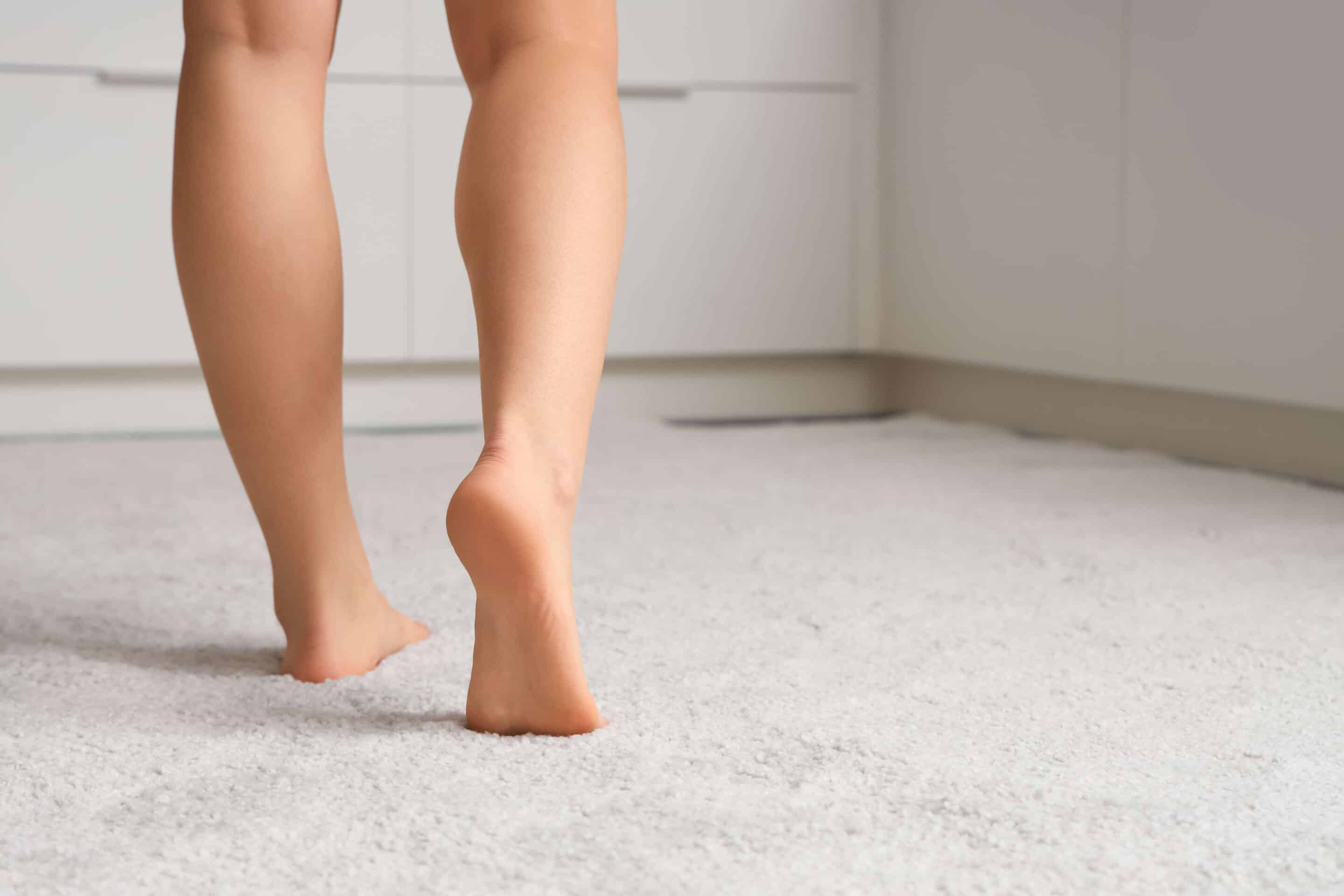 Barefoot woman walking on white carpet